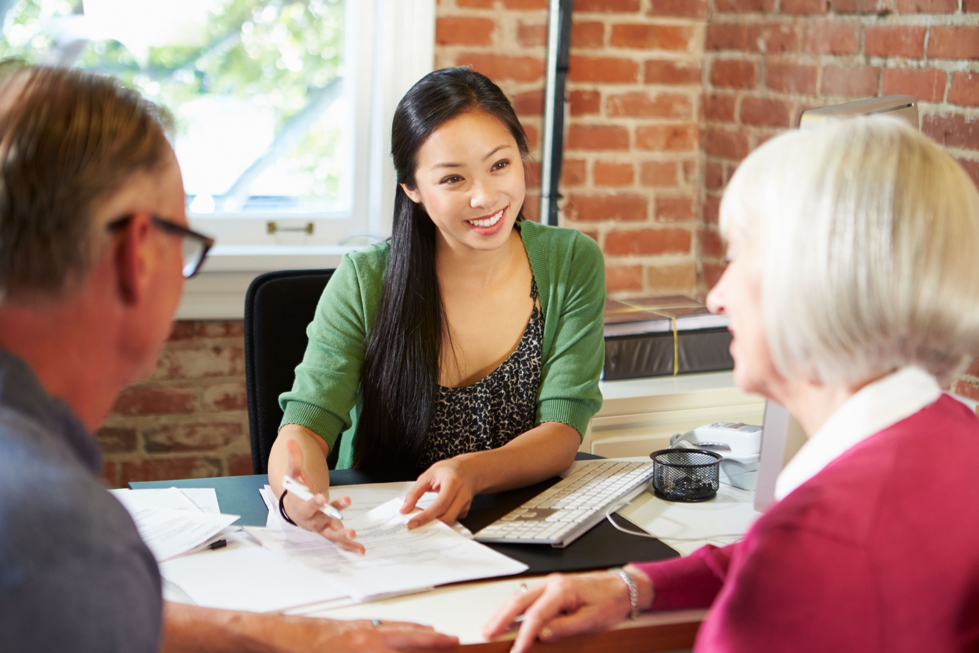 Senior Couple Meeting With Financial Advisor In Office